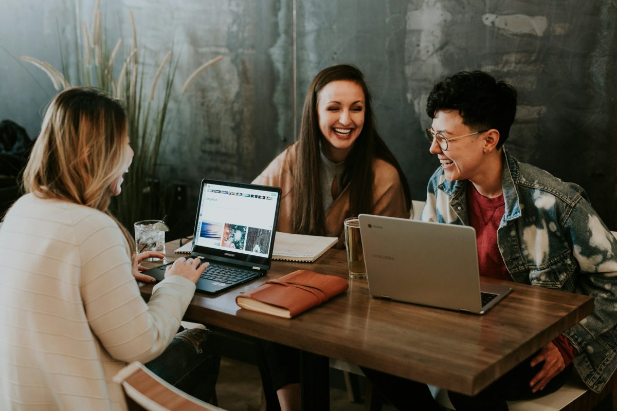 Young colleagues laughing together at a table